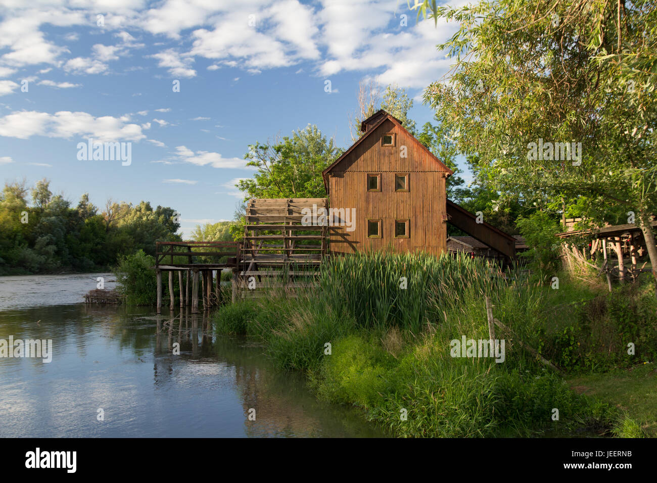 wooden watermill house near the river Stock Photo