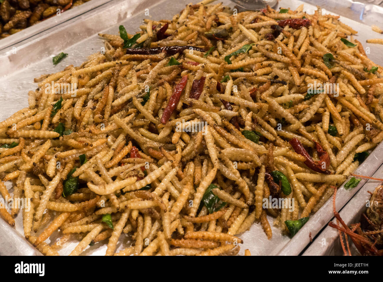 Deep fried caterpillars worms. Famous snack in Thailand. Stock Photo