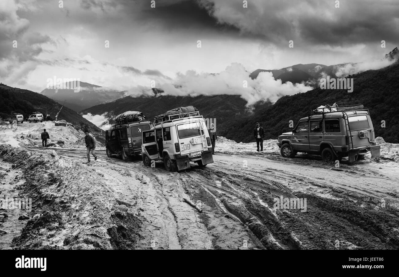 Vehicles stuck in deep mud following landslide along highway 229 and wait for rescue in Himalayas near Tawang, Arunachal Pradesh, India. Stock Photo
