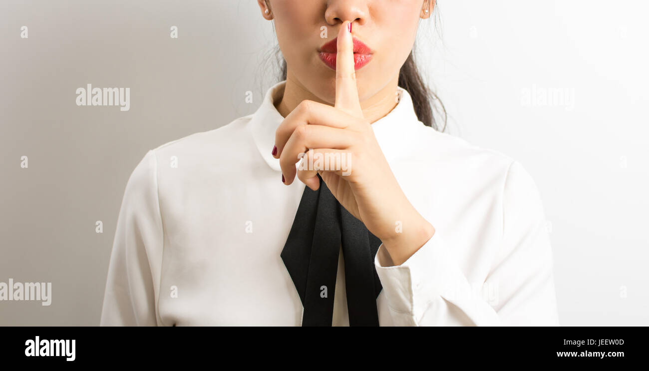 Shhhh! Businesswoman requiring silence to concentrate Stock Photo