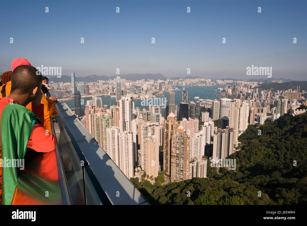 Horizontal view of Buddhist monks enjoying the view from up the Peak in Hong Kong, China. Stock Photo