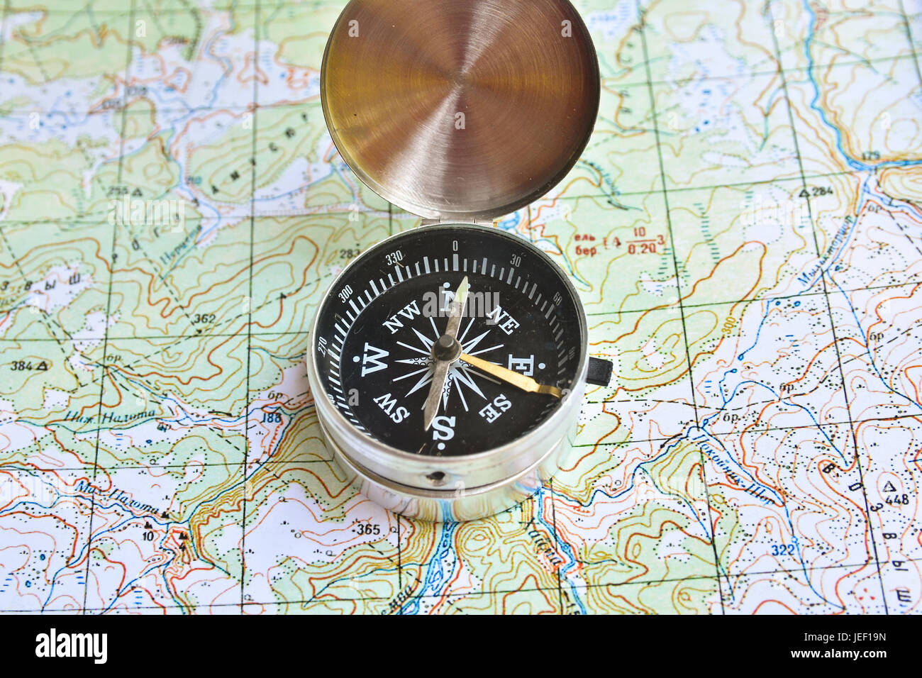 The compass lies on the map. Navigation tools needed for orientation