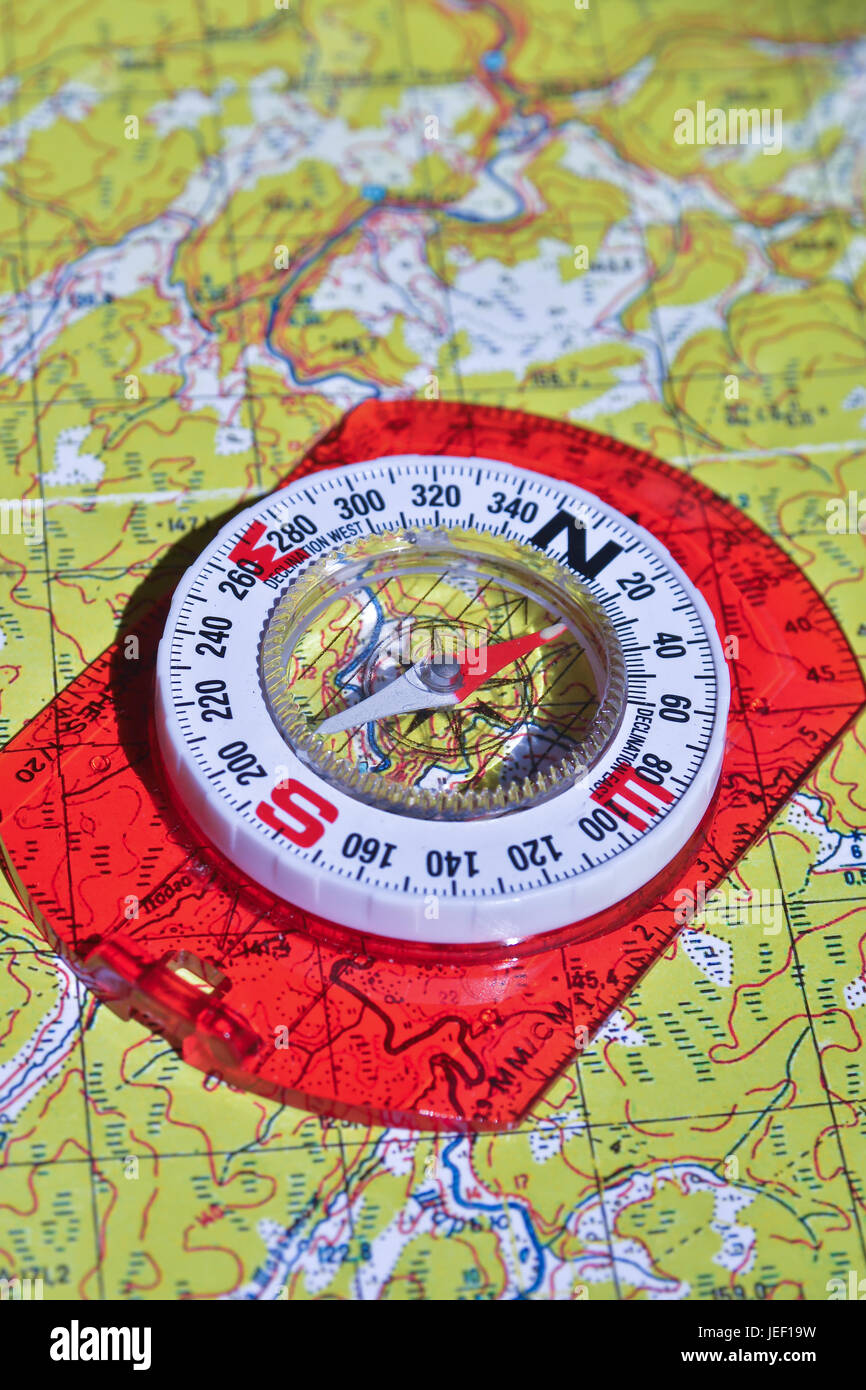 The compass lies on the map. Navigation tools needed for orientation