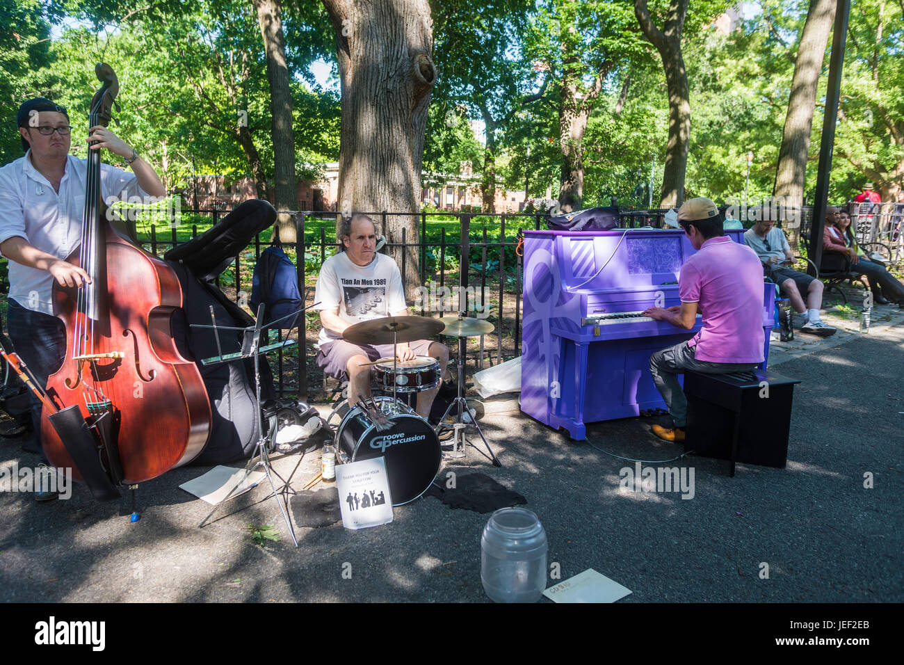New York, USA 10 June 2016 - Buskers incorporate the Sing For Hope piano in Tompkins Square Park, in the East Village. The Purple Piano is dedicated to the Artist Formerly Known as Prince.©Stacy Walsh Rosenstock Stock Photo