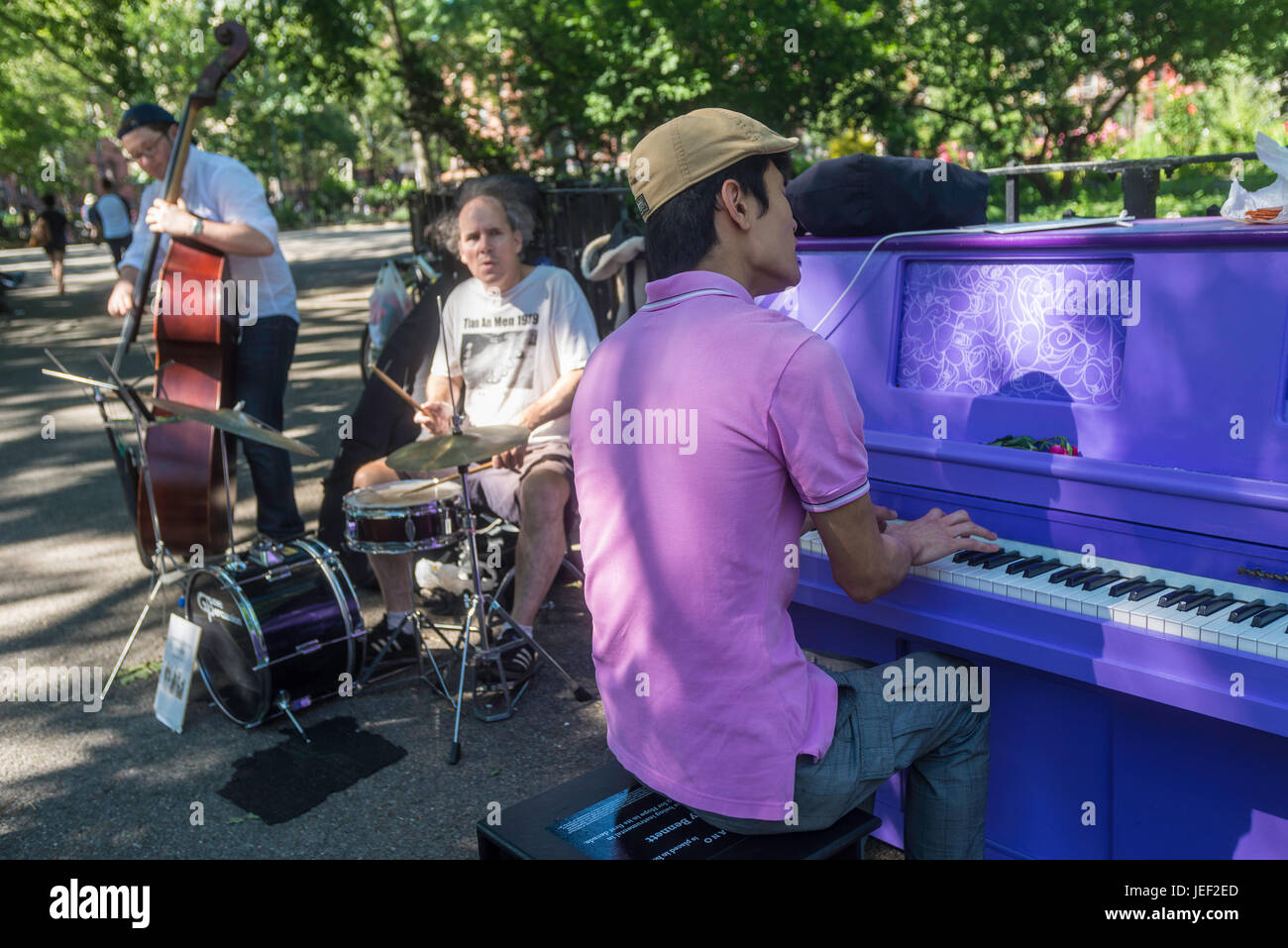 New York, USA 10 June 2016 - New Yorkers play the Sing For Hope piano in Tompkins Square Park, in the East Village. The Purple Piano is dedicated to the Artist Formerly Known as Prince.©Stacy Walsh Rosenstock Stock Photo