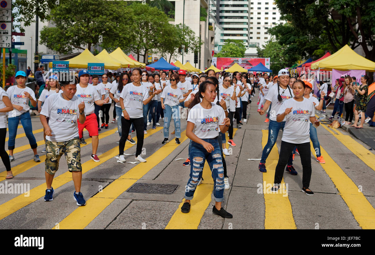 Filipino workers in Hong Kong create a massive line dance on the streets of Central. Stock Photo