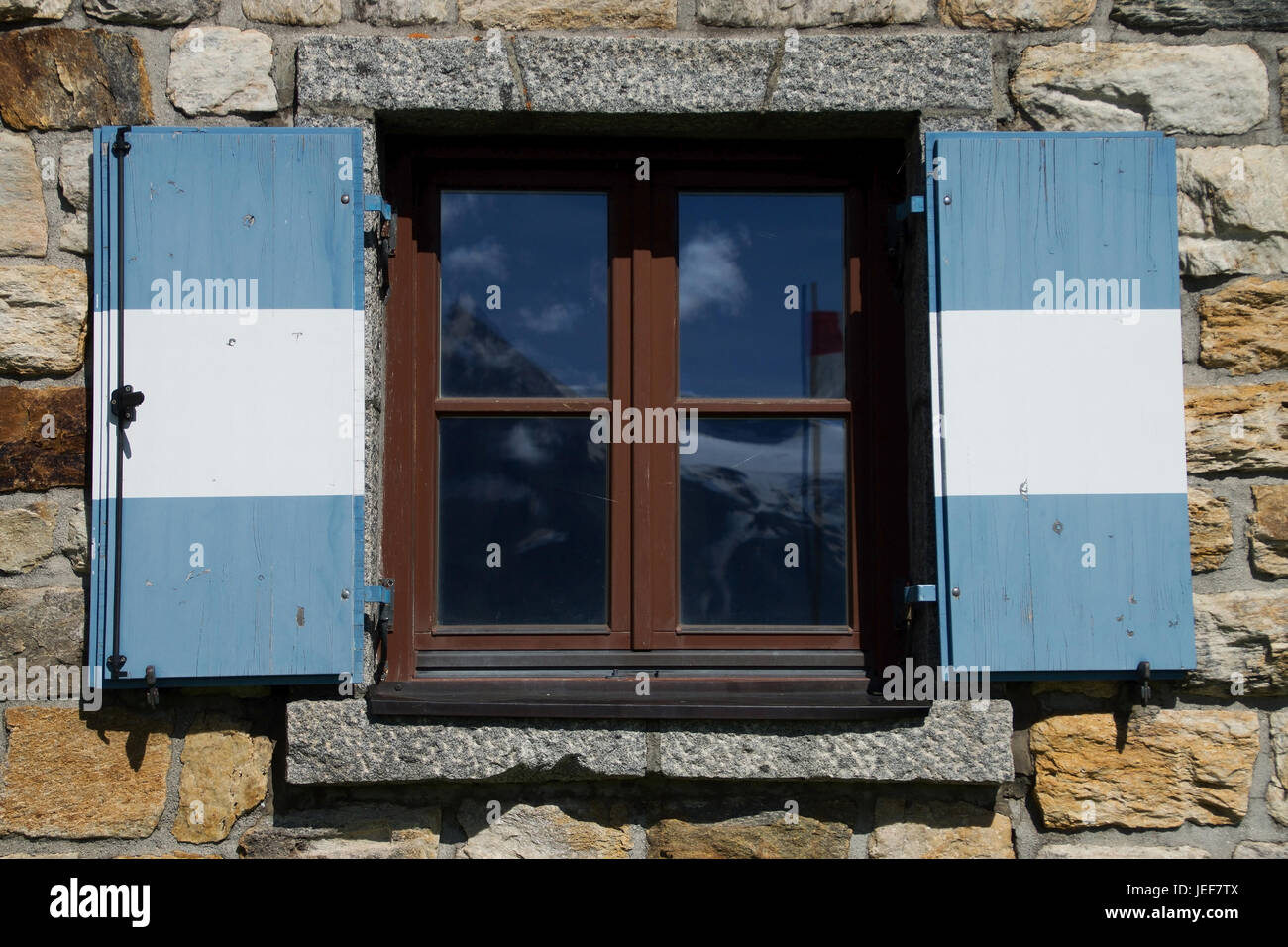 Typical window with blue white shutters in Austria., Typisches Fenster mit blau weissen Fensterläden in Österreich. Stock Photo