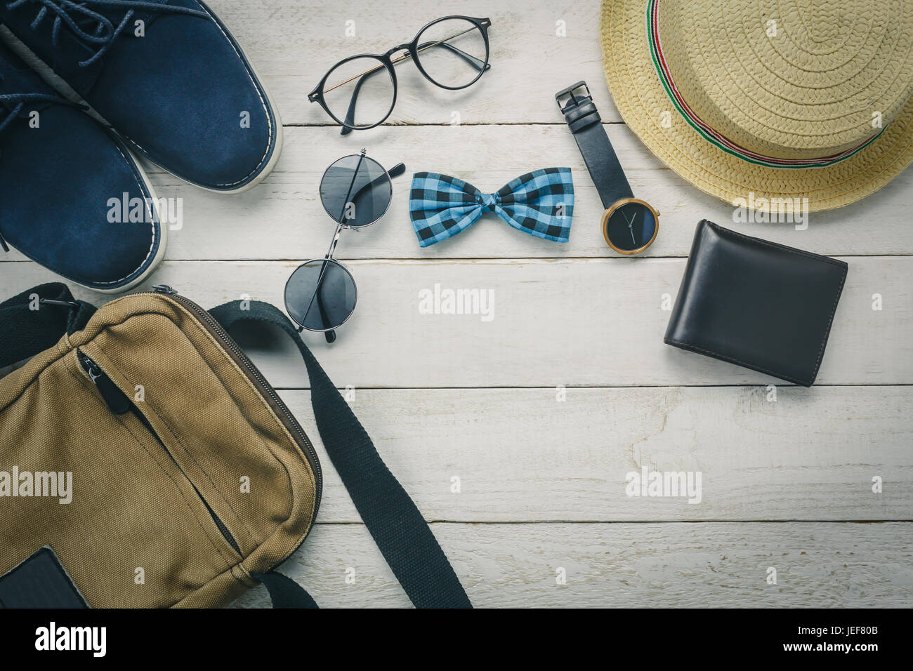Top view accessoires to travel with man clothing concept. bow tie,wallet on  wooden background.watch,sunglasses,bag,hat and shoes on wood table Stock  Photo - Alamy