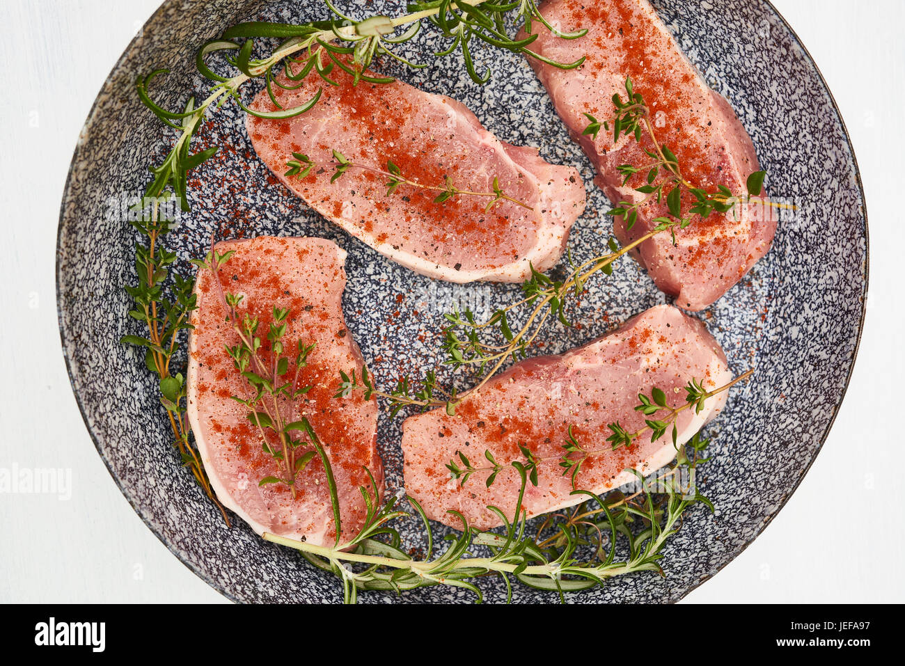 Raw pork chops in pan ready for cooking Stock Photo