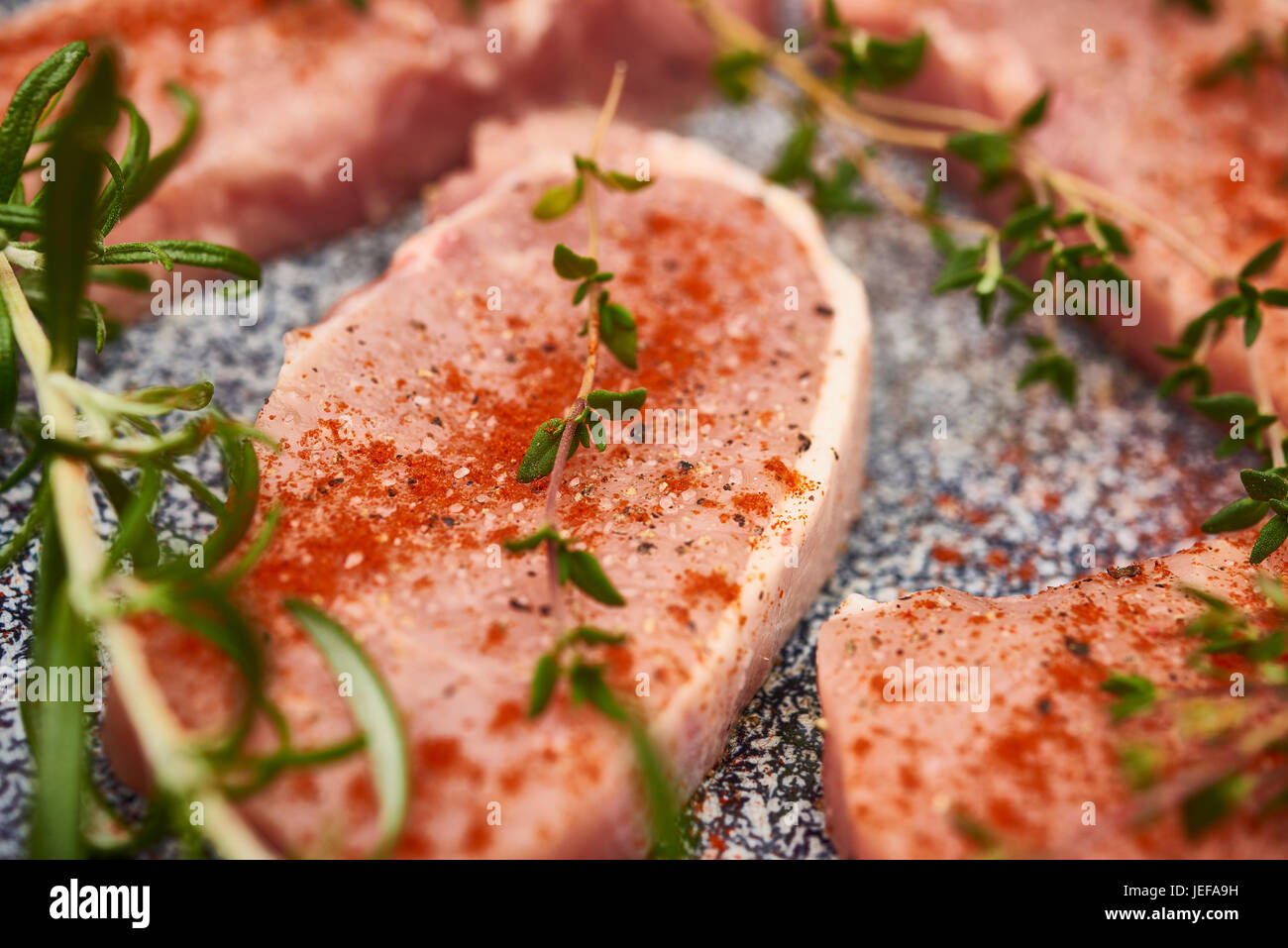 Raw pork chops in pan ready for cooking with cauliflower and potatoes Stock Photo