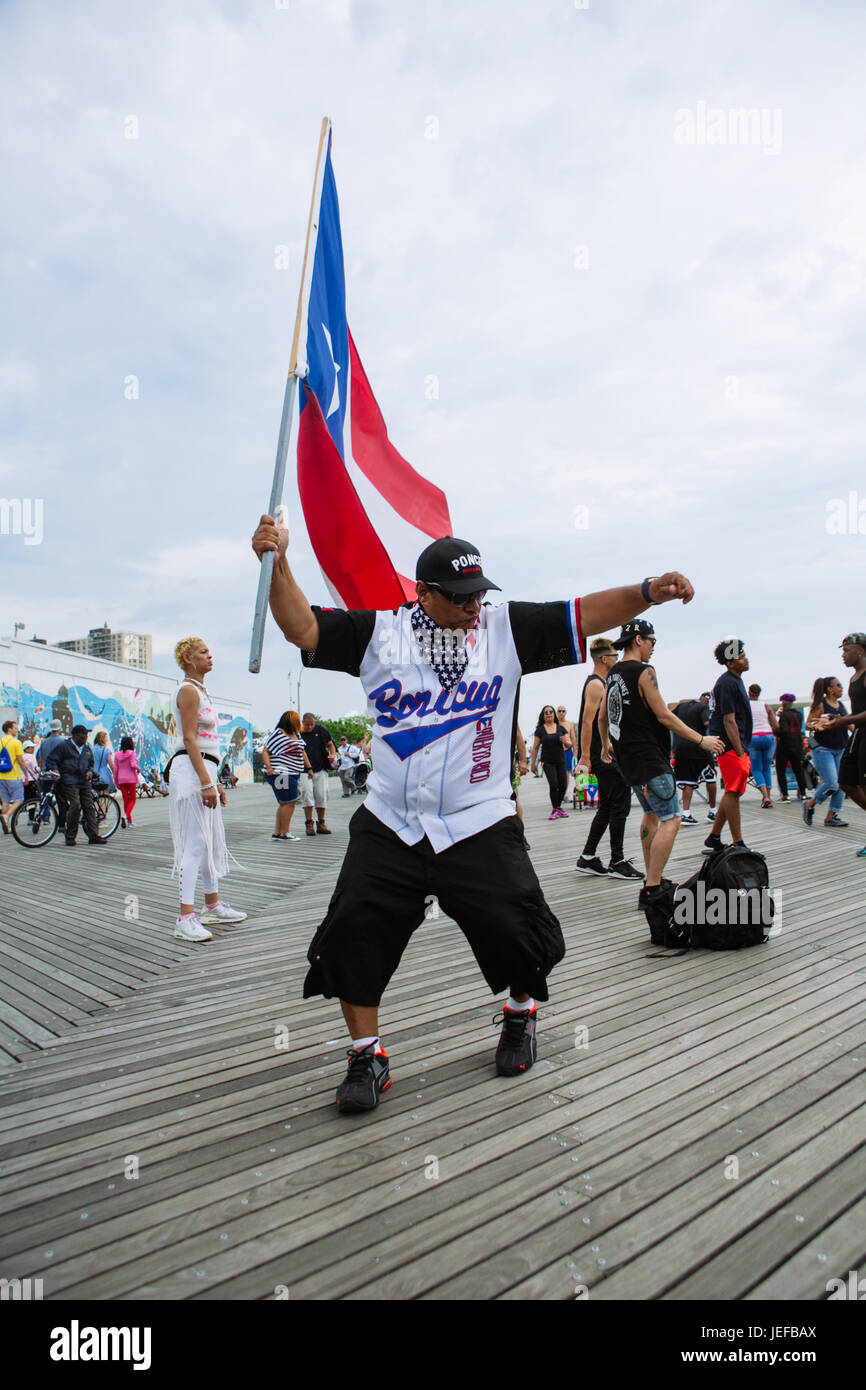 Puerto rican people celebrating with Puerto Rico flags in Coney Island boardwalk during summer weekend, Brooklyn, USA Stock Photo