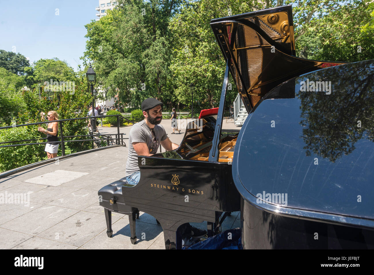 New York, NY - Man and woman pianists rehearsing on a Steinway double baby  grand piano for the Summer Concert series in Washington Square Park. ©Stacy  Walsh Rosenstock Stock Photo - Alamy