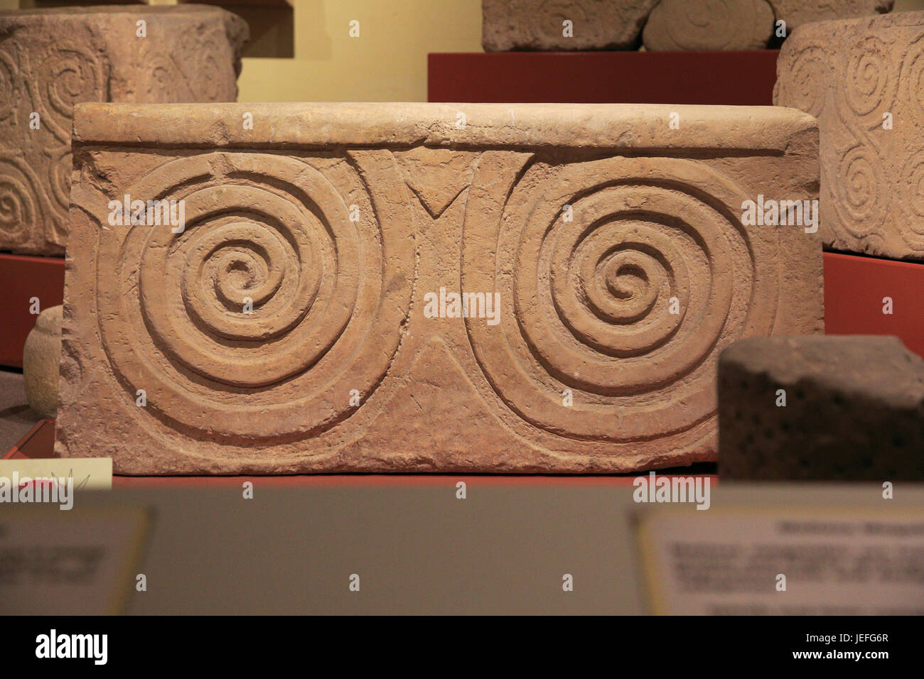 Carved stone neolithic spiral design, National Museum of Archaeology, Valletta, Malta Stock Photo