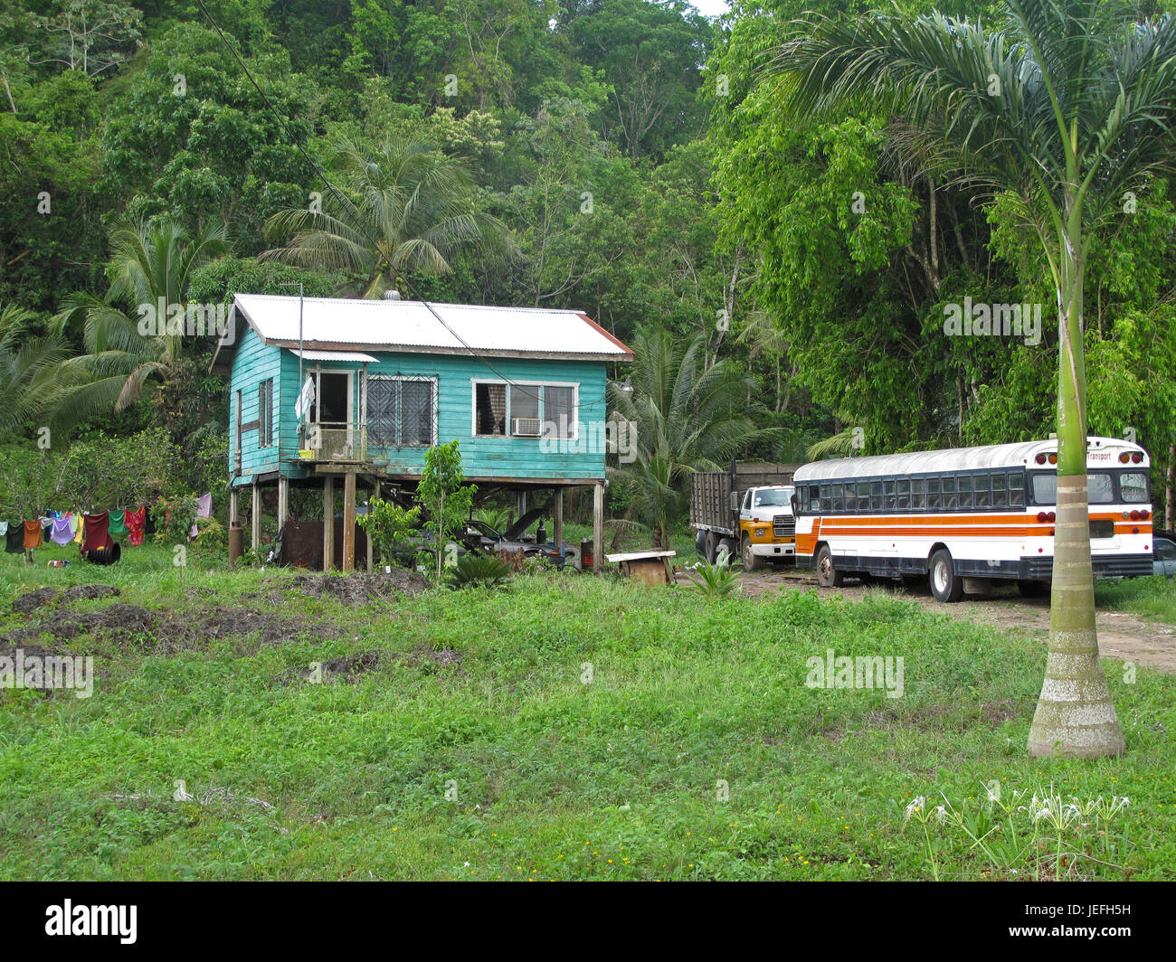 Traditional typical carribean house and old truck in Belize Stock Photo