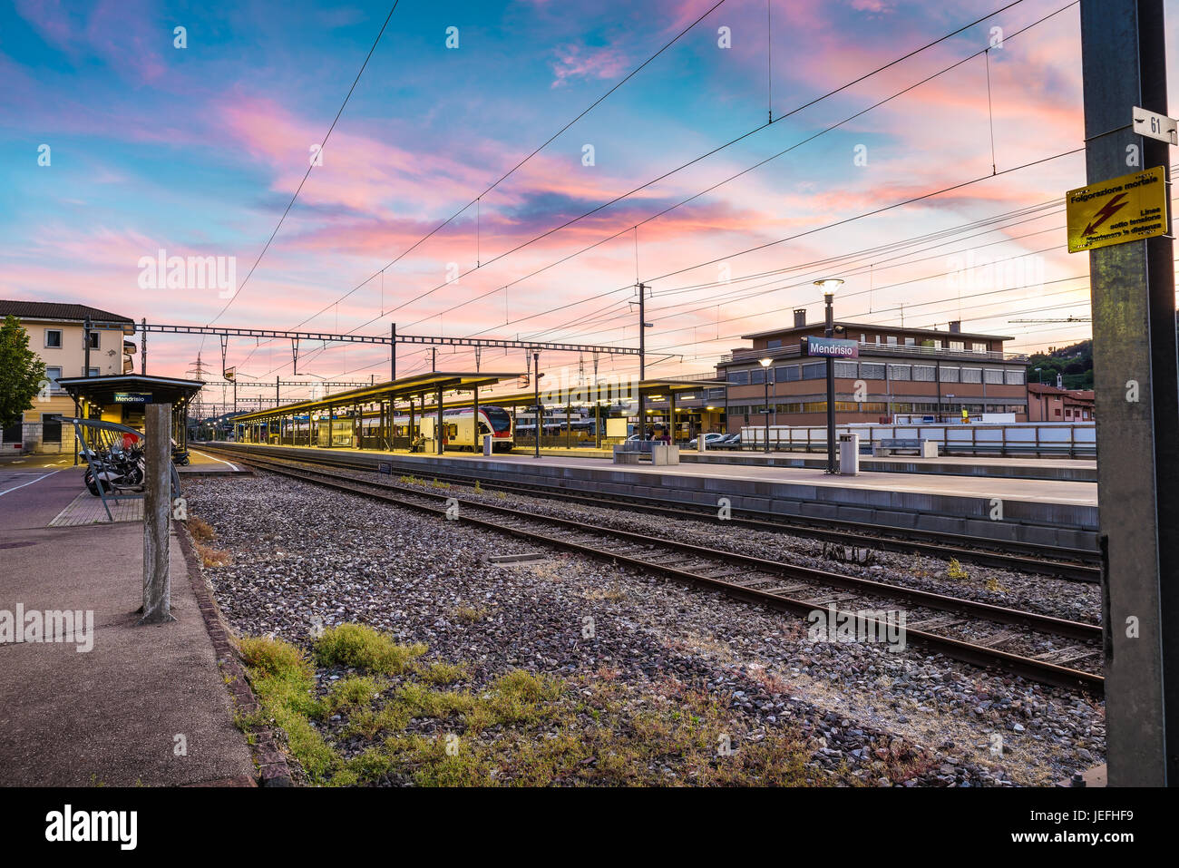 Colorful sky at a Swiss railway station. Example of public transport on ...