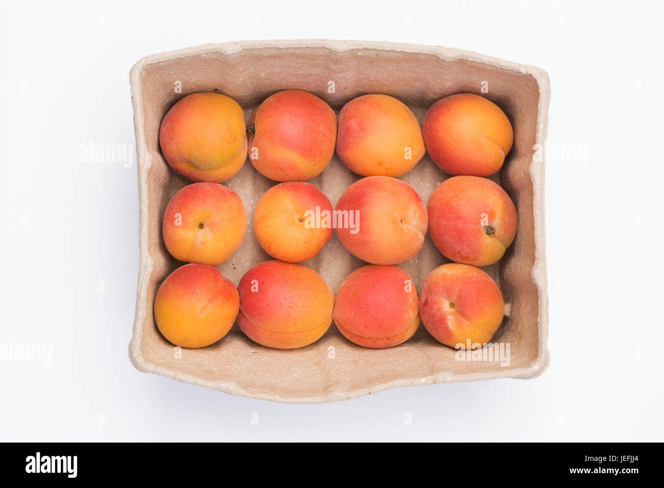 Prunus armeniaca. Box of fresh Apricots. Stock Photo