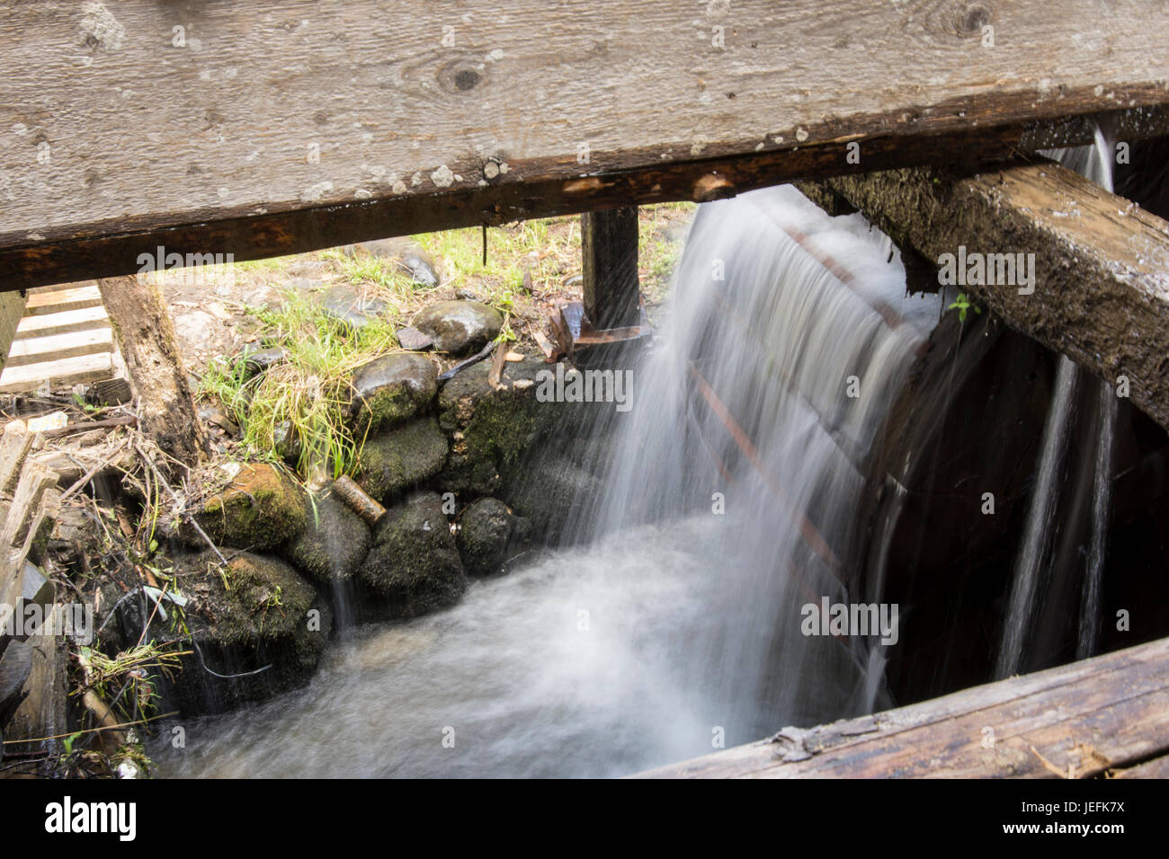 A traditional carpet washing machine in a river in the Maramures region Stock Photo