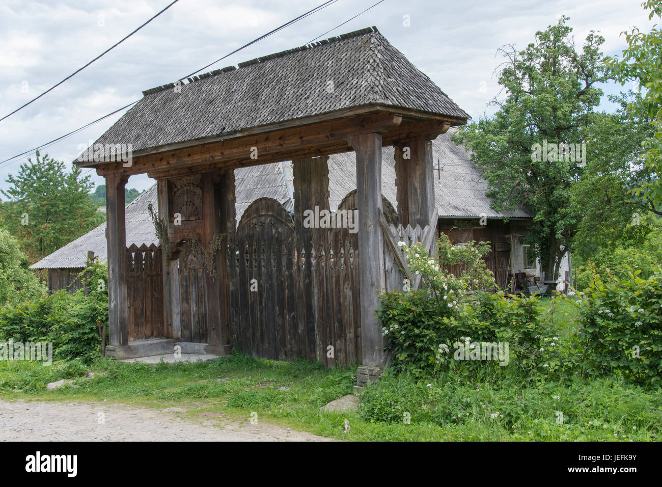 Typical wooden decorated house gate in Maramures region Stock Photo