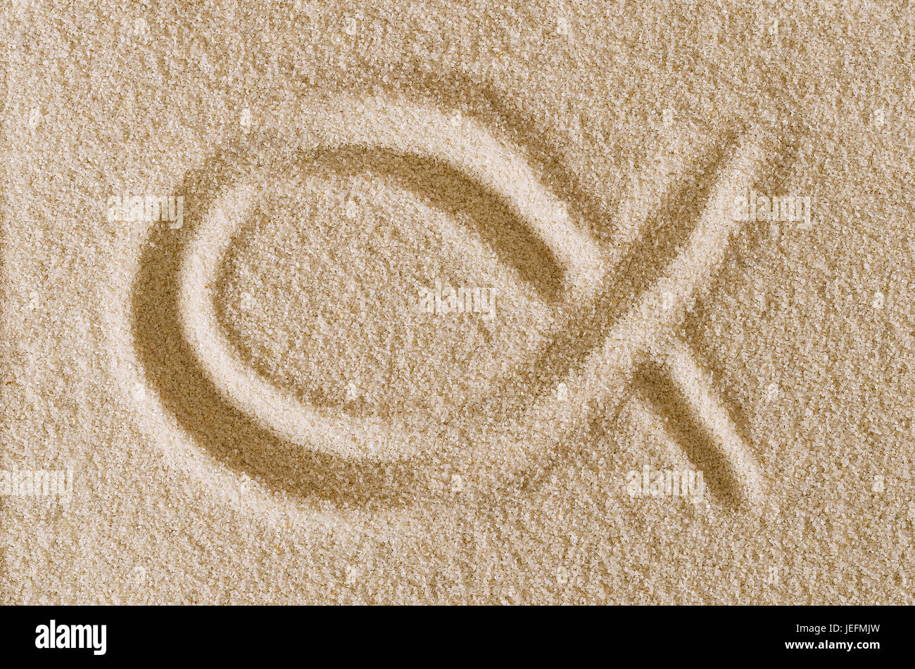 Jesus Fish symbol, drawn in sand. Imprint and shape of the ichthys, also ichthus, in ocher grains of sand. The sign consists of two intersecting arcs. Stock Photo