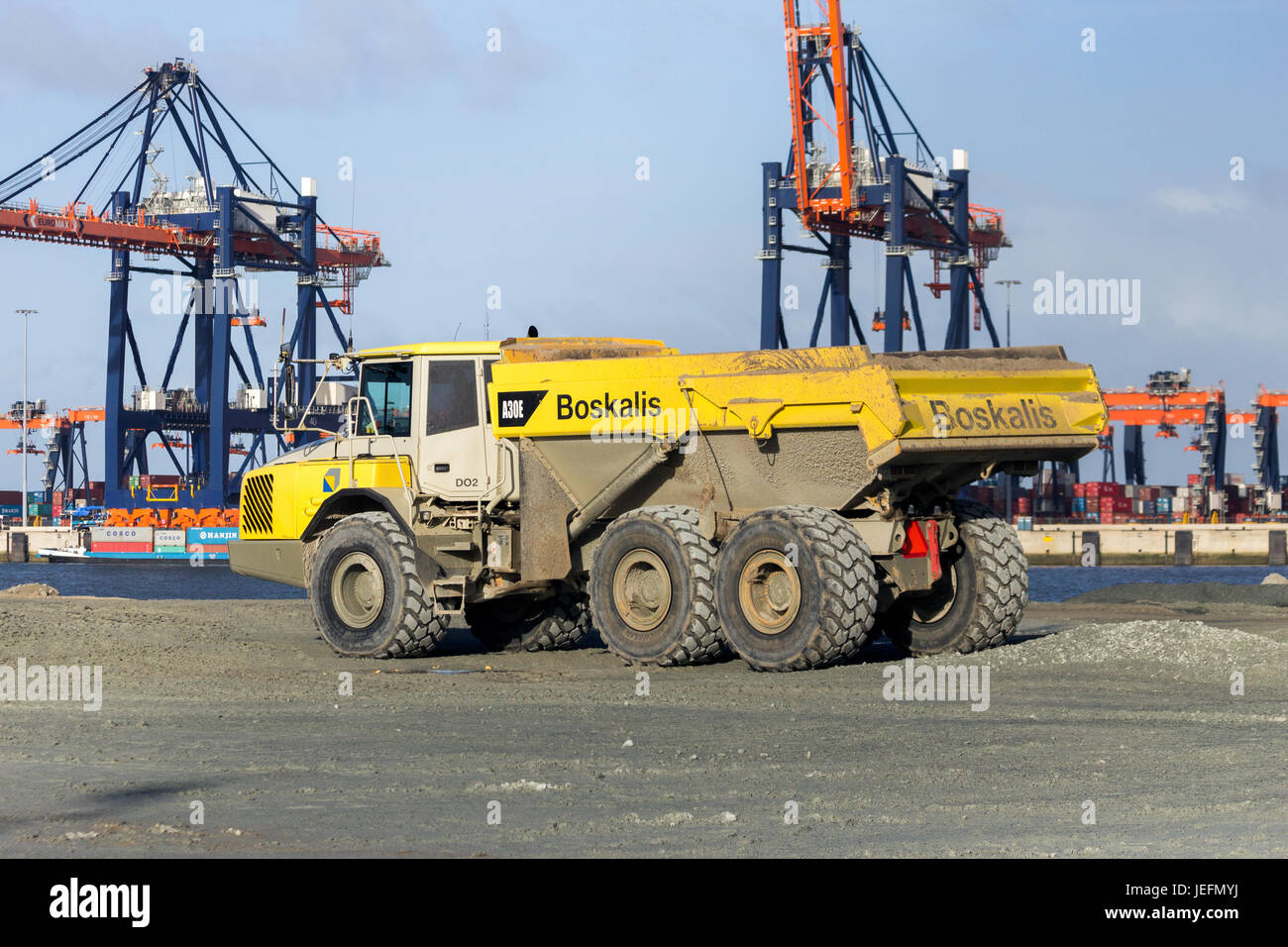 ROTTERDAM, NETHERLANDS - JAN 13, 2012: Boskalis dump truck on the construction site of a new harbor in sea, called Maasvlakte 2, in the Port of Rotter Stock Photo