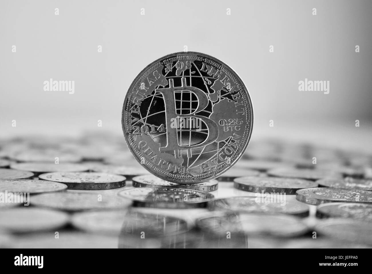 Digital currency physical silver bitcoin coin in black and white scene