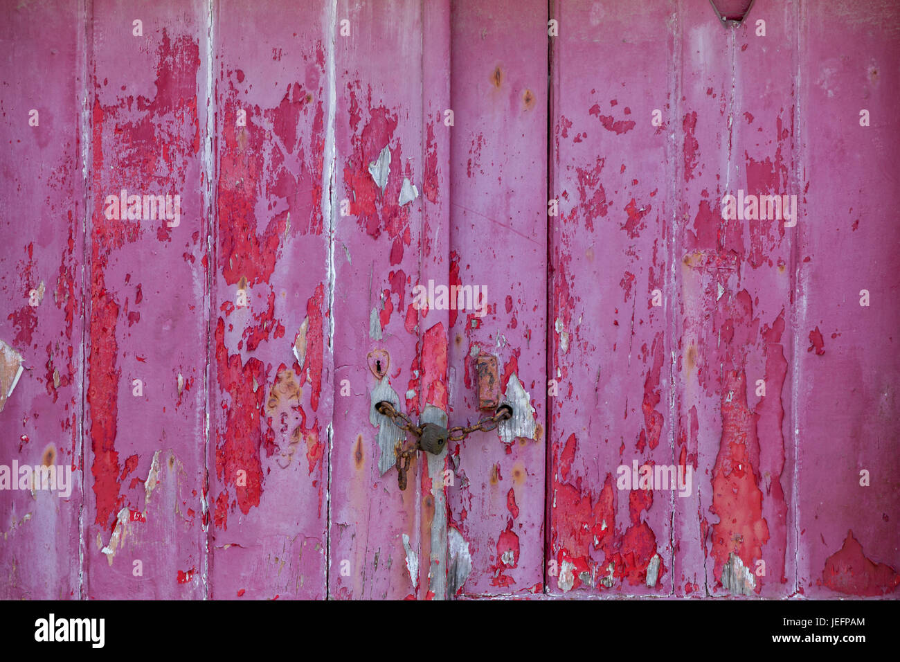 old raspberry colorer door with damaged texture Stock Photo