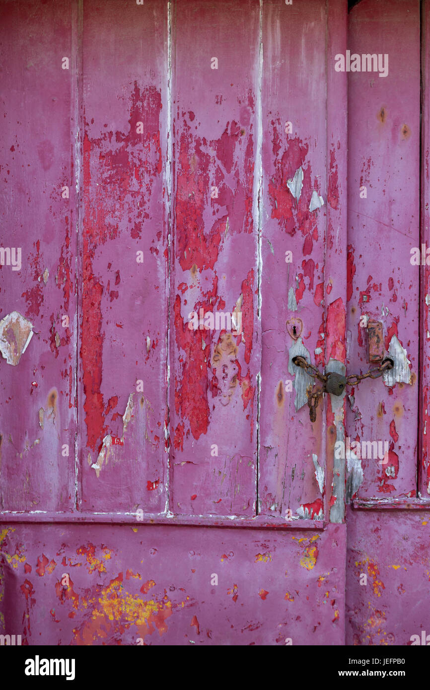 old raspberry colorer door with damaged texture Stock Photo