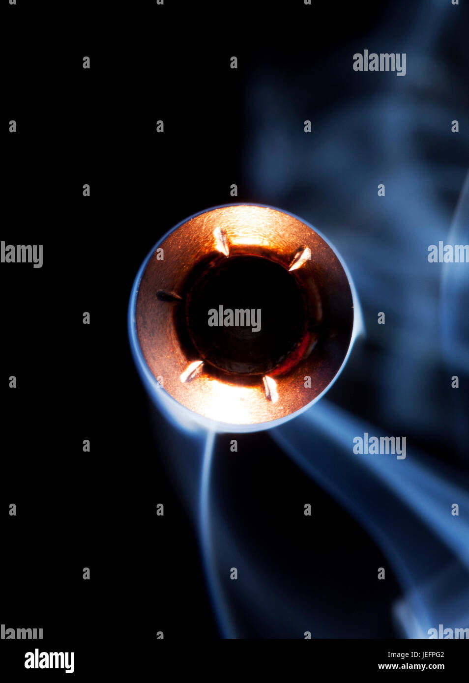 Copper jacketed hollow point and smoke on a black background Stock