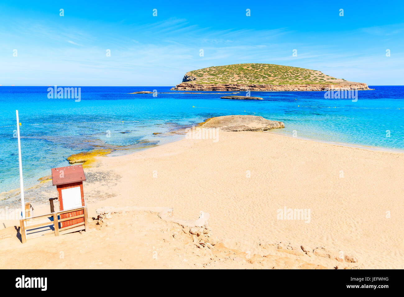 Lifeguard tower on beautiful Cala Comte beach famous for its azure crystal clear shallow sea water, Ibiza island, Spain Stock Photo