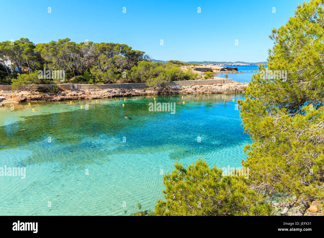 View of beautiful Cala Gracio bay with azure sea water at early morning, Ibiza island, Spain Stock Photo