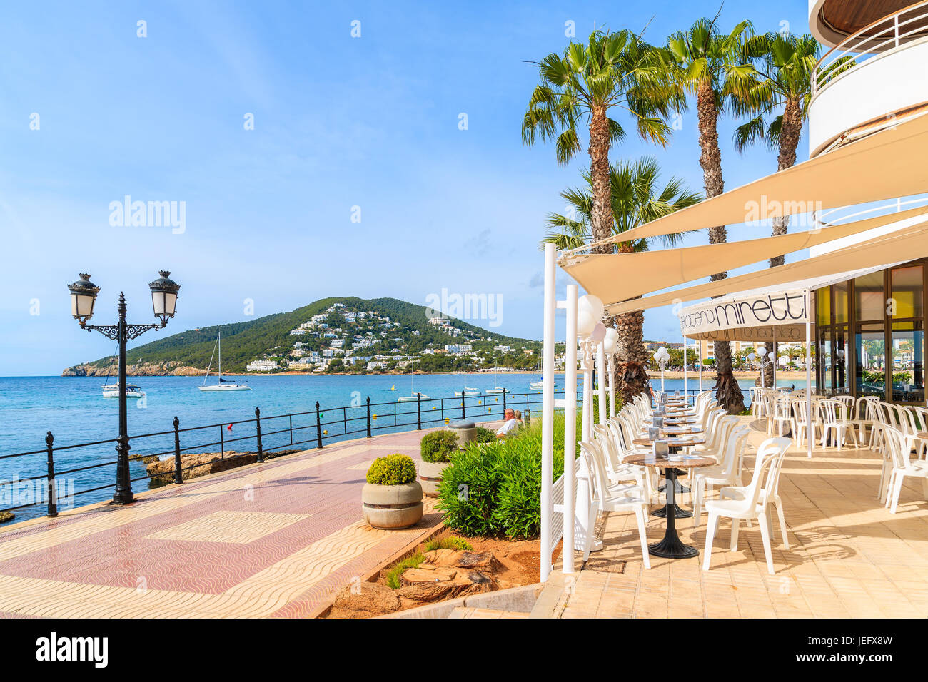 IBIZA ISLAND, SPAIN - MAY 21, 2017: Restaurant on coastal promenade along sea in Santa Eularia town, Ibiza island, Spain. Stock Photo