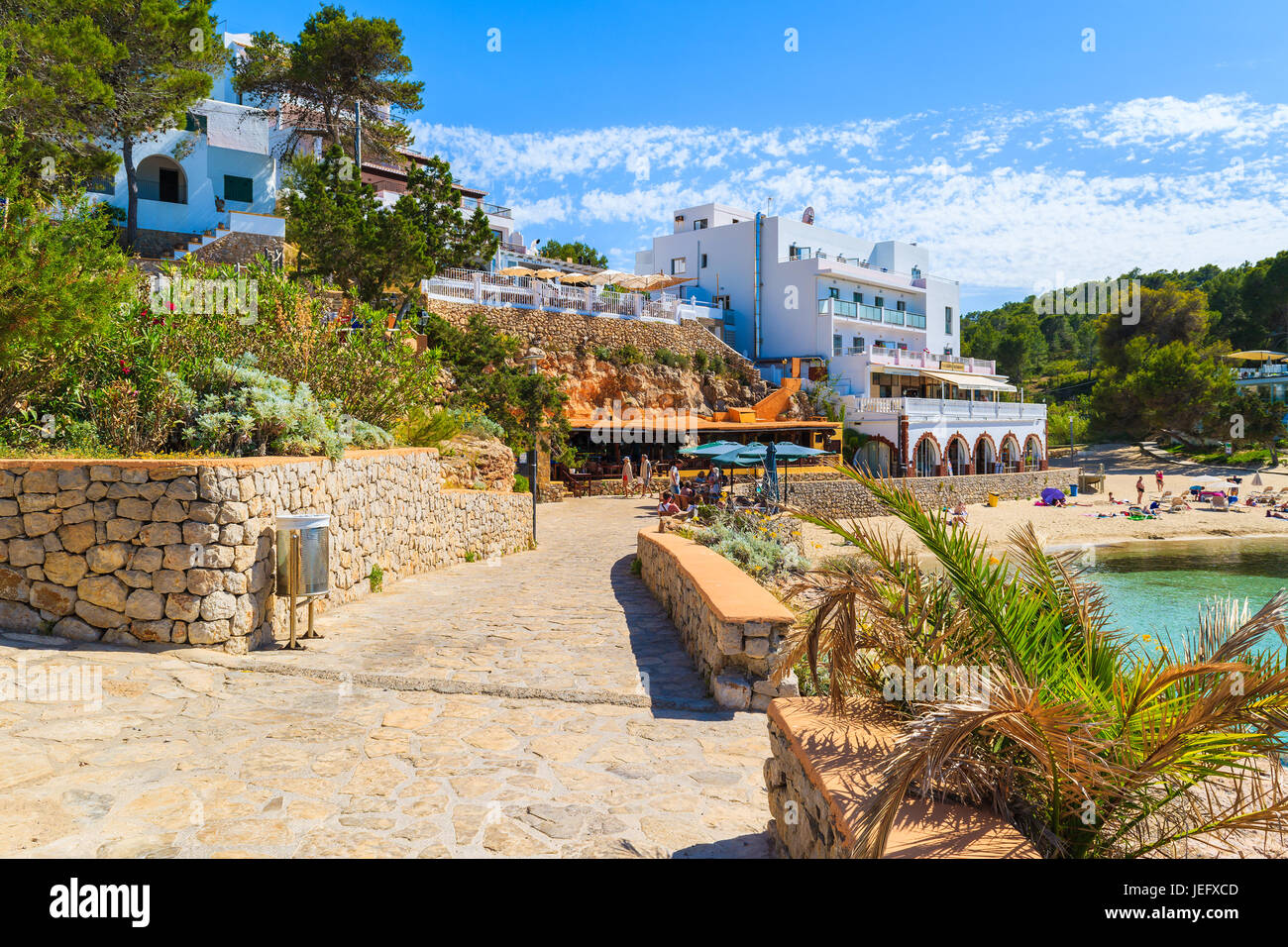 CALA PORTINATX BAY, IBIZA ISLAND - MAY 22, 2017: View of coastal promenade and hotels with restaurants in Cala Portinatx bay, Ibiza island, Spain. Stock Photo