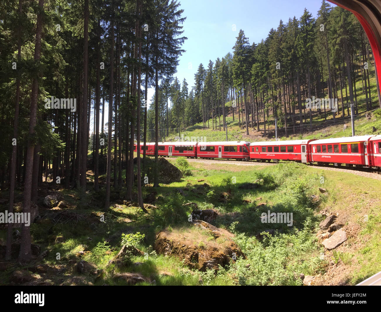 BERNINA EXPRESS train climbing towards Lake Bianco. Photo: Tony Gale Stock Photo
