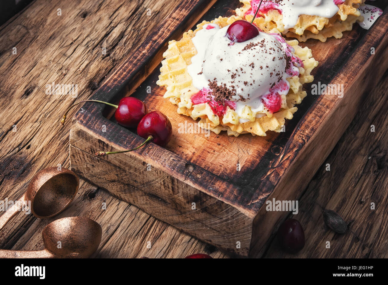 Ice cream on baked wafers with cherries Stock Photo