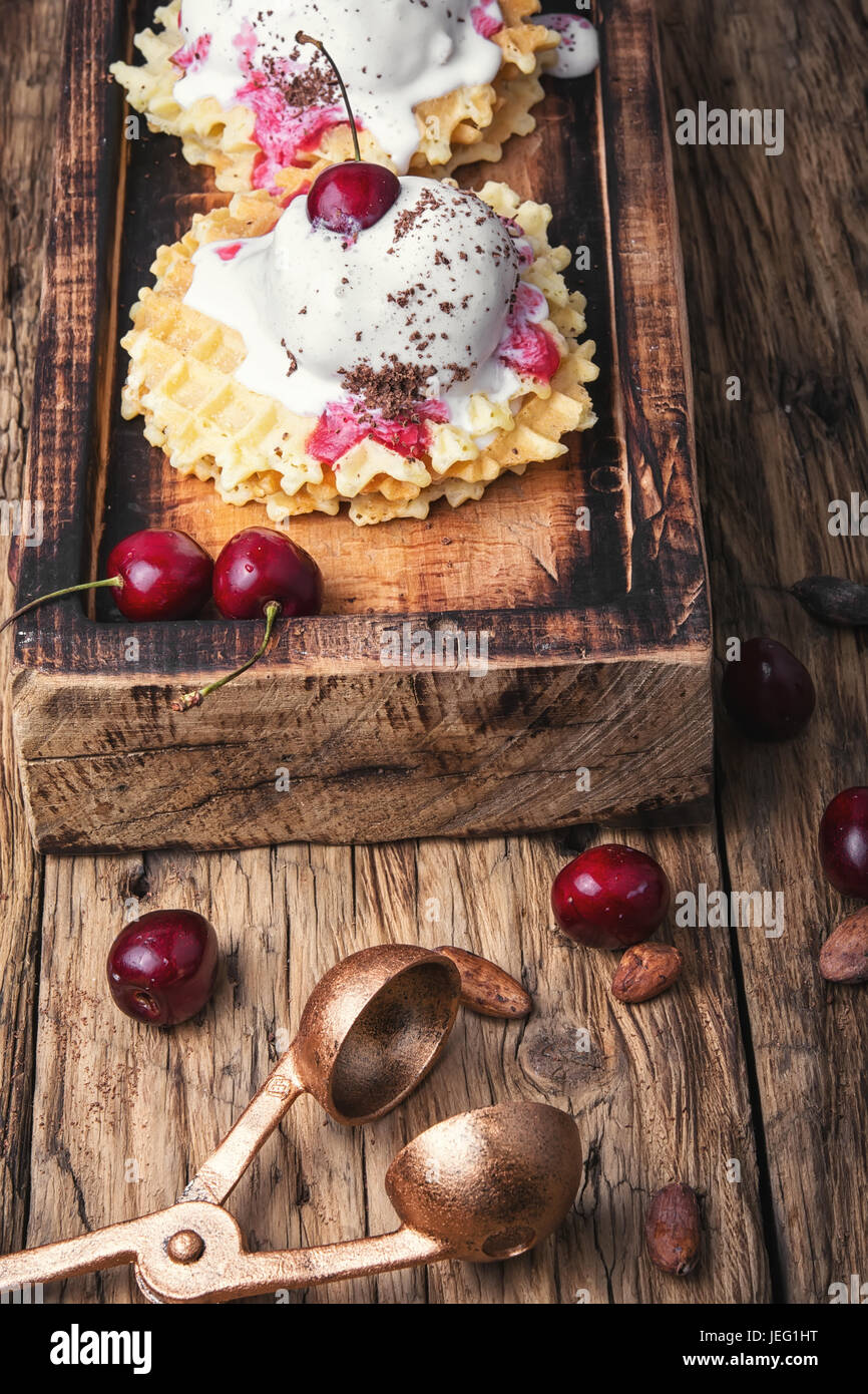 Ice cream on baked wafers with cherries Stock Photo