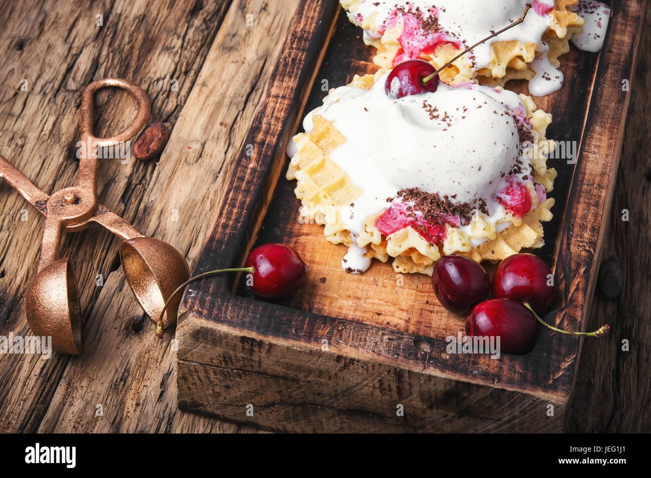 Ice cream on baked wafers with cherries Stock Photo