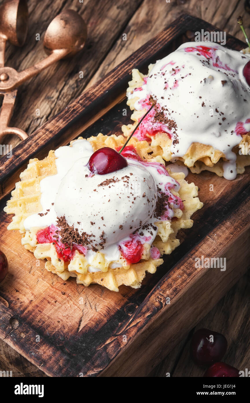 Ice cream on baked wafers with cherries Stock Photo