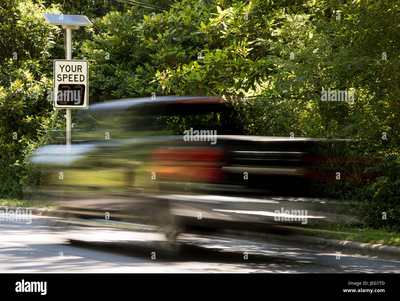 Pickup truck exceeds speed limit as it passes electronic speed camera in Chapel Hill, NC, USA Stock Photo