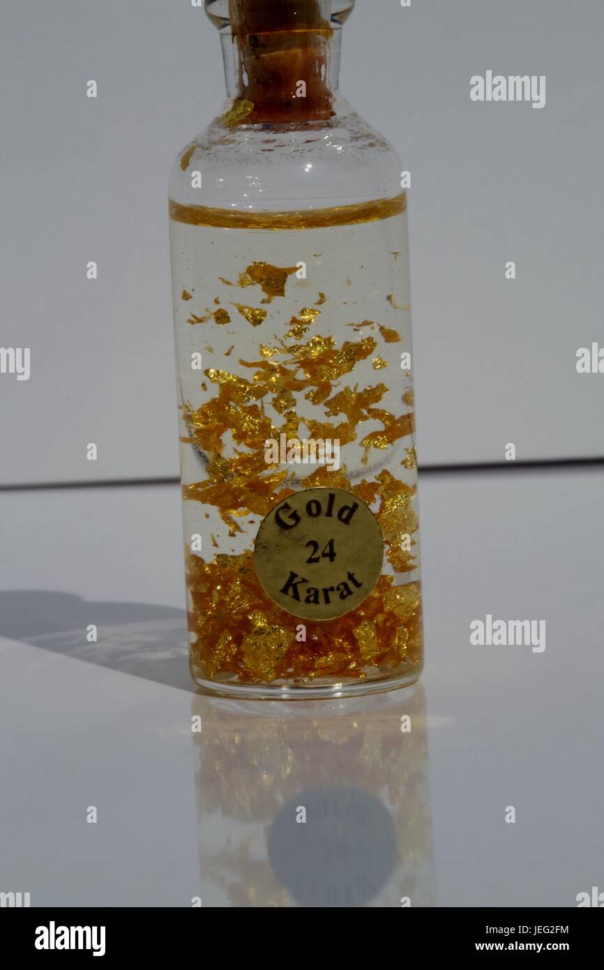 24 Karat Gold Flakes in a Bottle. Macro Image. UK, June, 2017 Stock