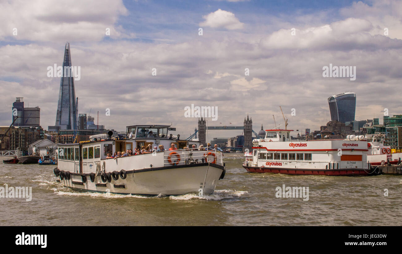 Pleasure boats along the River Thames. In the background (left to right) is The Shard Skyscraper, Tower Bridge and the Walkie Talkie Skyscraper, Londo Stock Photo