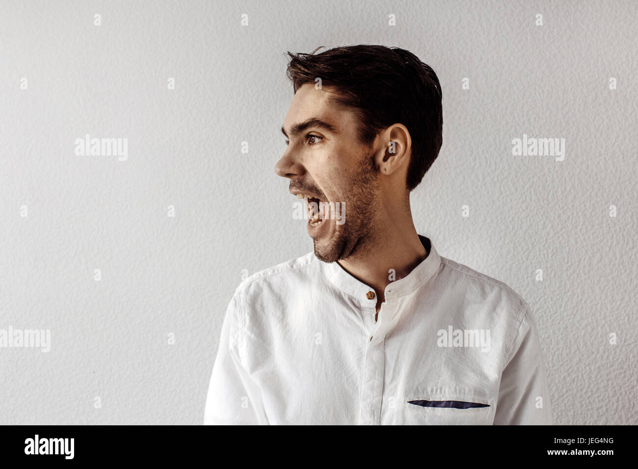 Man standing and yelling Stock Photo
