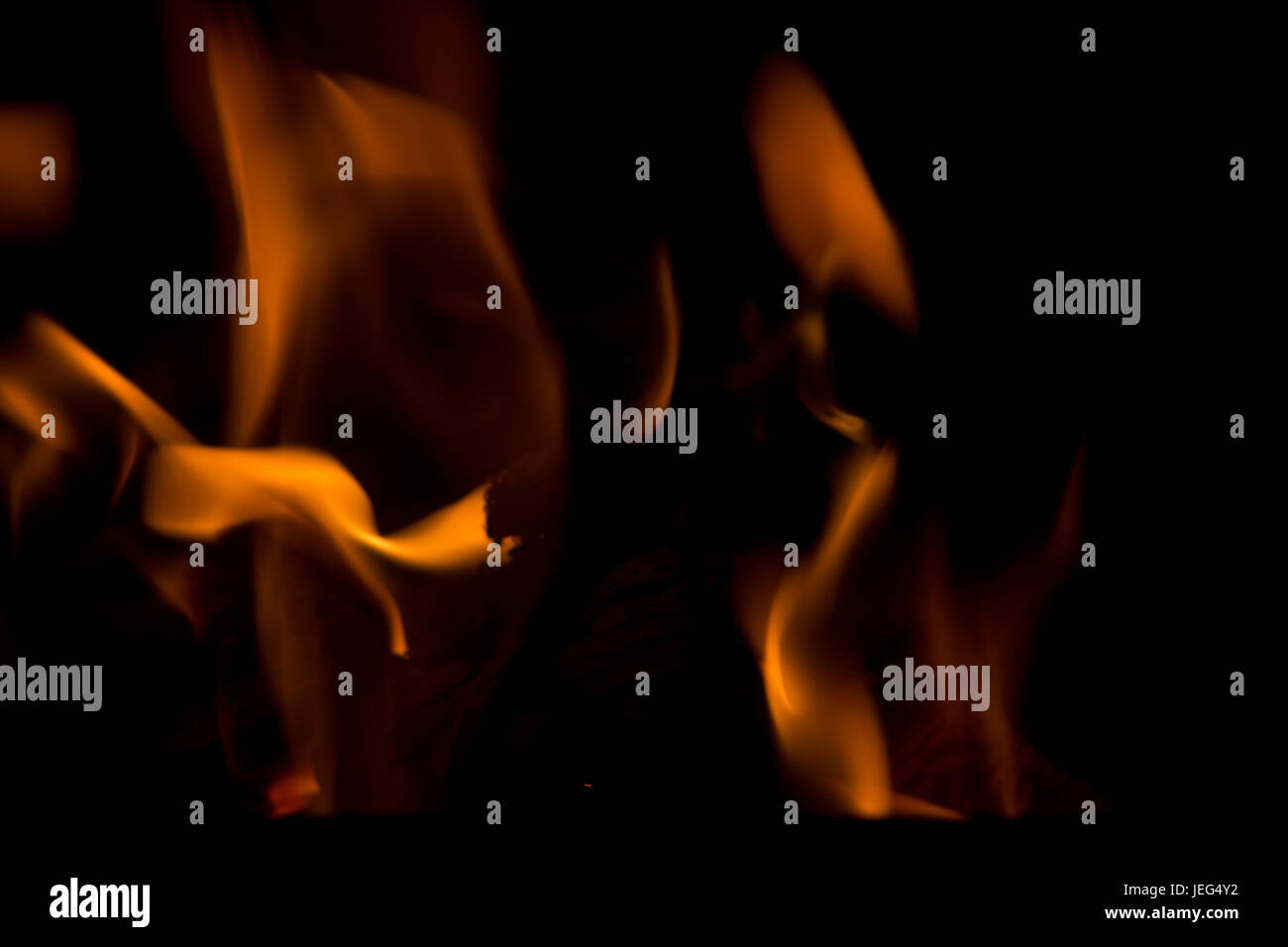 Abstract Image of Flames against a dark backgrouind.  Using your imagination, you can almost see shapes of different creatures in the fire. Stock Photo