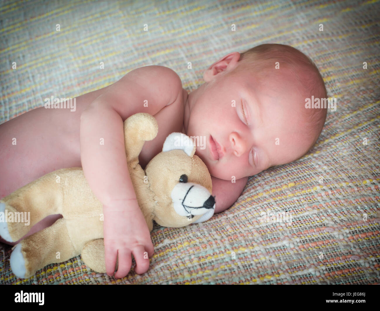 Little baby sleeps with a toy teddy bear Stock Photo Alamy