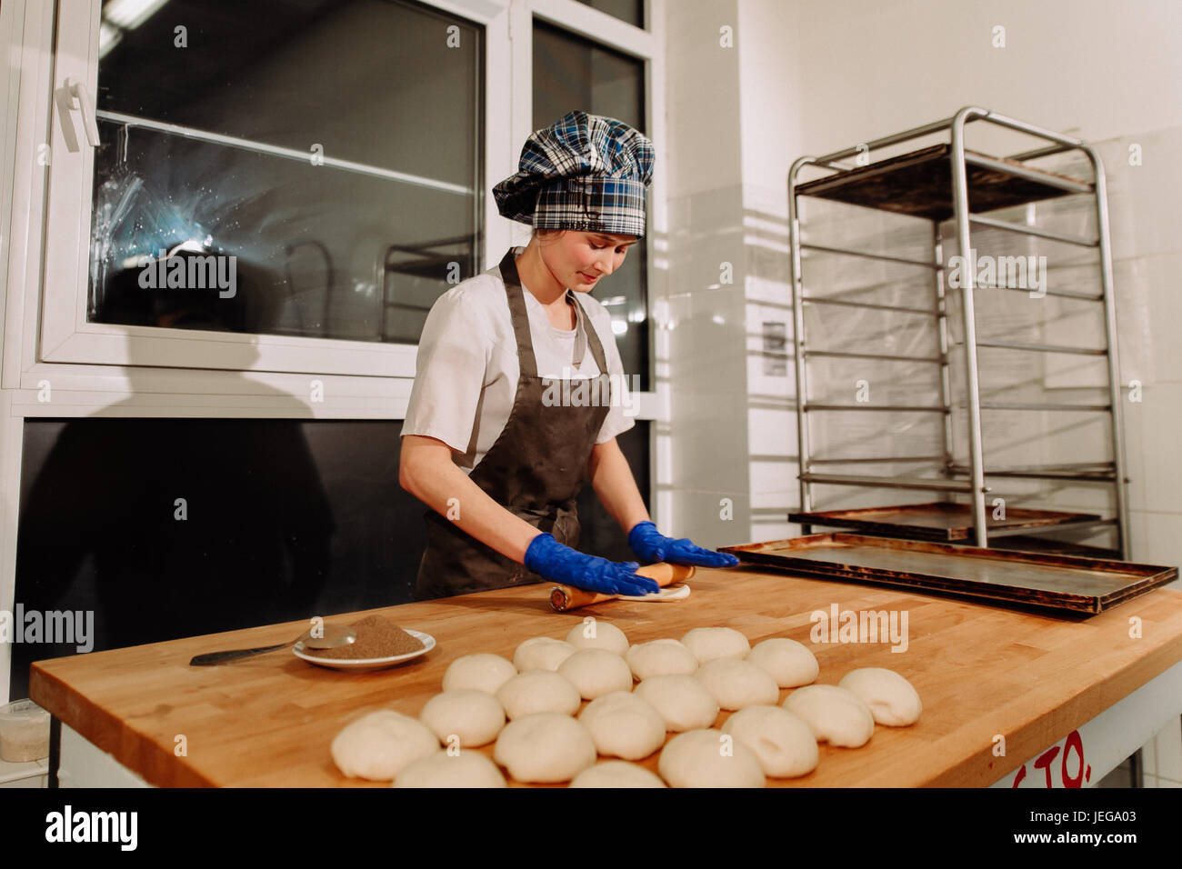 a Baker making cinnamon rolls Stock Photo Alamy