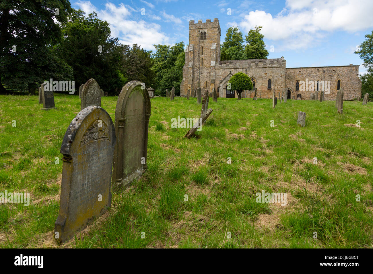 Yorkshire, England, UK.  Graveyard, St. Oswald's Church, Hauxwell, near Leyburn. Stock Photo