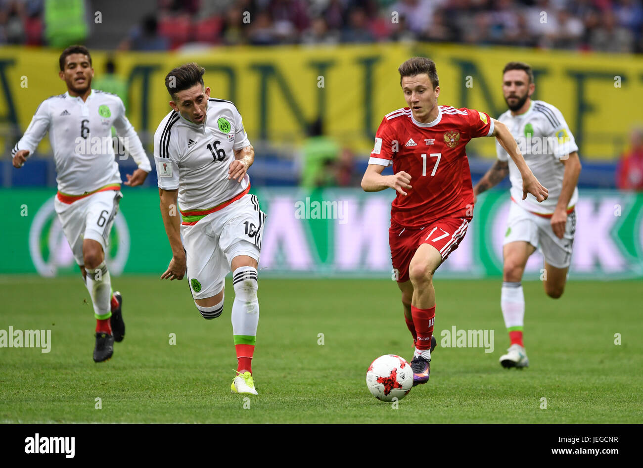 Kazan, Russia. 24th June, 2017. Mexico's Hector Herrera (L) Russia's Alexandr Golovin vie for the ball during the group stage match pitting Mexico against Russia at the Kazan Arena in Kazan, Russia, 24 June 2017. Photo: Marius Becker/dpa/Alamy Live News Stock Photo