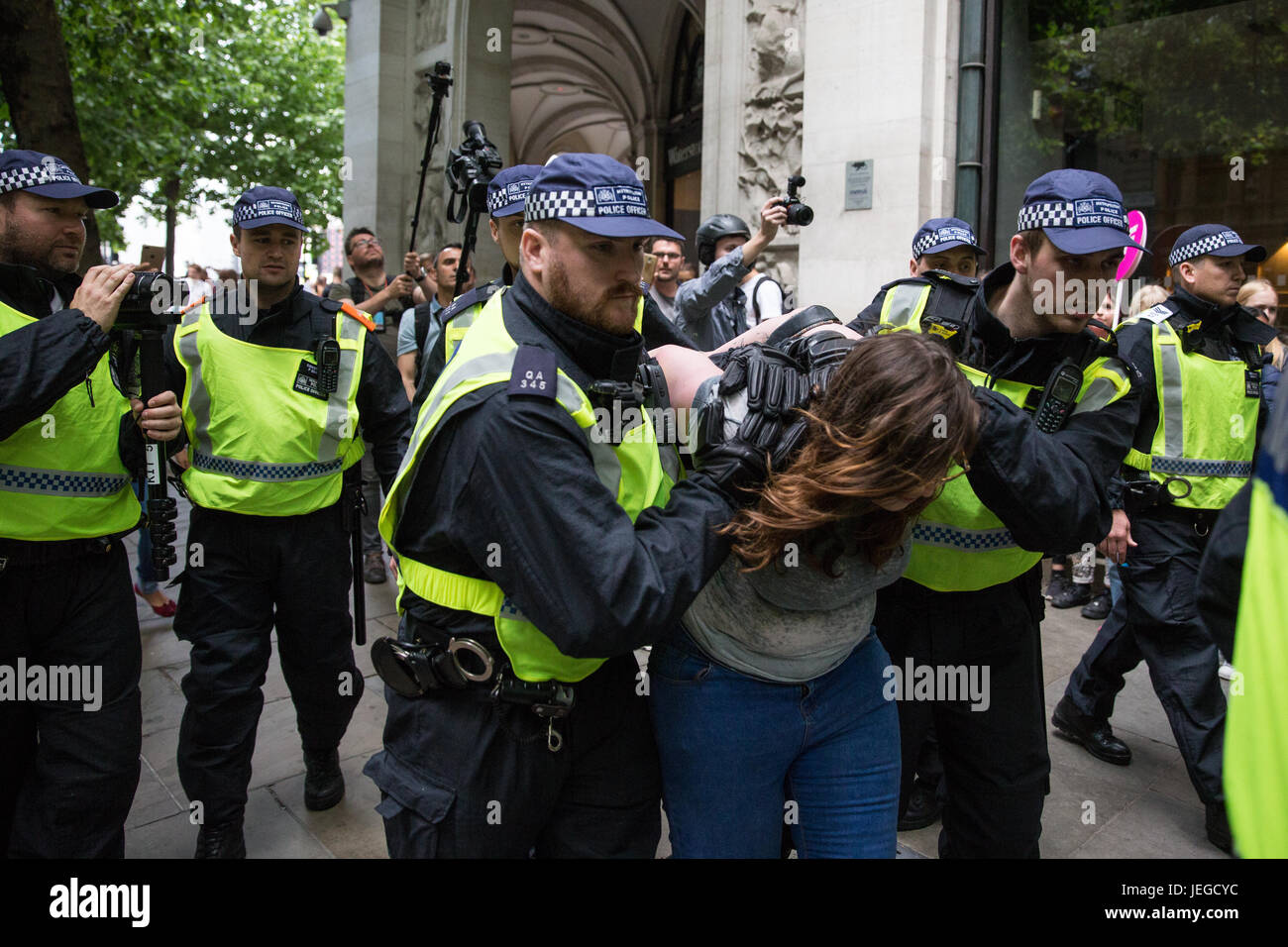 London, UK. 24th June, 2017. Police officers arrest a woman among anti-fascists holding a counter-protest to a march by the far-right English Defence League in central London. Credit: Mark Kerrison/Alamy Live News Stock Photo