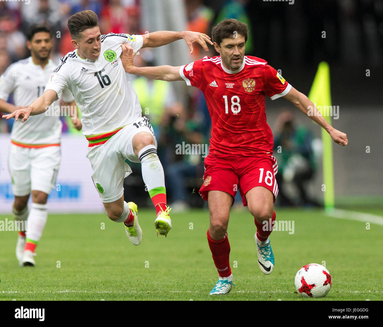 Kazan, Russia. 24th June, 2017. Hector Herrera(C) of Mexico vies with Yury Zhirkov(R) of Russia during group A match between Russia and Mexico at the 2017 FIFA Confederations Cup in Kazan, Russia, on June 24, 2017. Mexico won 2-1. Credit: Bai Xueqi/Xinhua/Alamy Live News Stock Photo