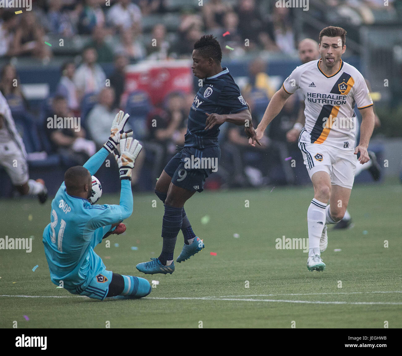 Los Angeles, USA. 24th June, 2017. Goalkeeper Clement Diop (L) of Los Angeles Galaxy stops a shot during the 2017 Major League Soccer (MLS) match between Los Angeles Galaxy and Sporting Kansas City, in Carson, the United States, June 24, 2017. Kansas City won 2-1. Credit: Javier Rojas/Xinhua/Alamy Live News Stock Photo