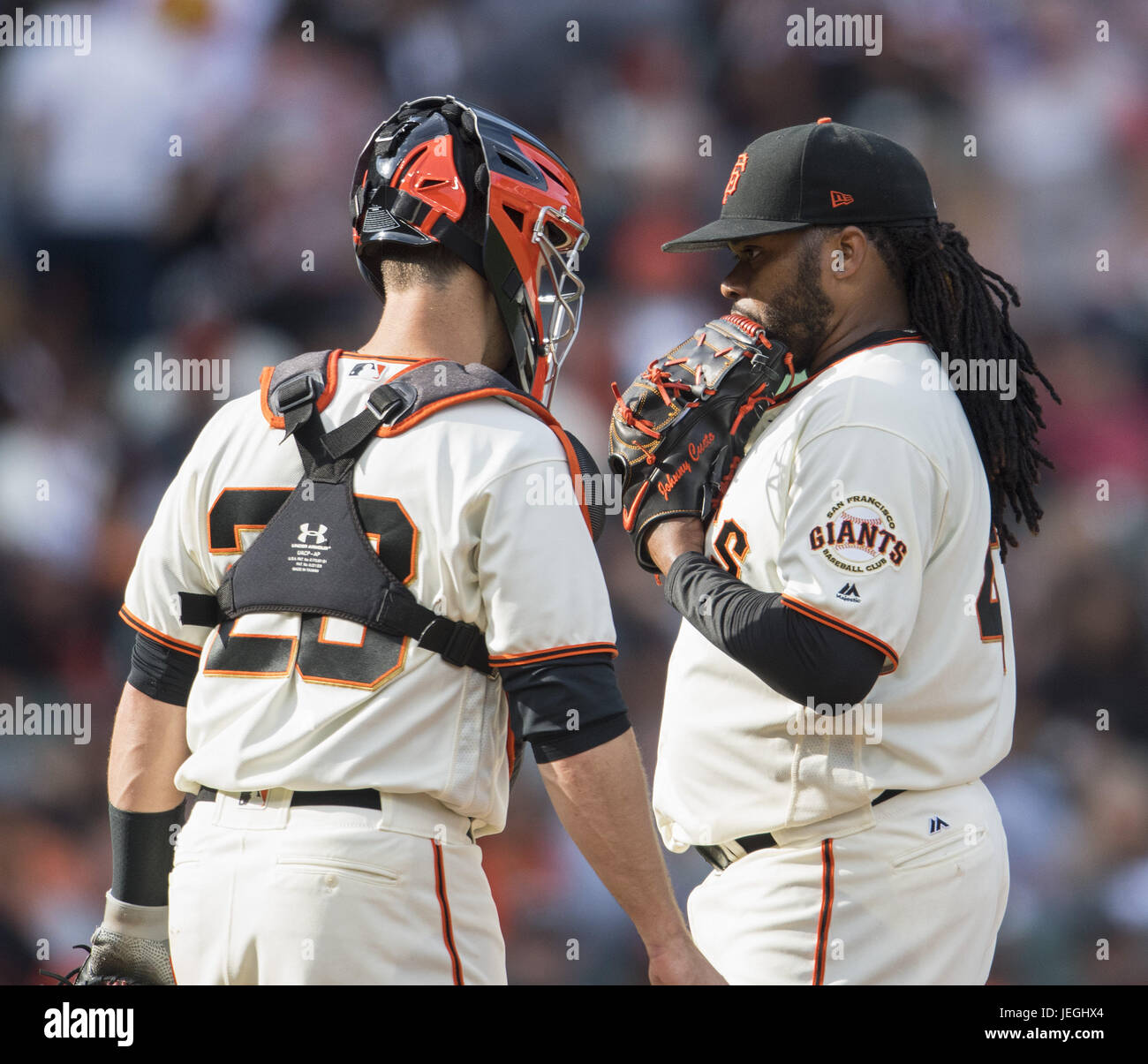 San Francisco, California, USA. 24th June, 2017. After NY left fielder Yoenis Cespedes' sixth inning single, San Francisco Giants catcher Buster Posey (28) walks to the mound to talk with San Francisco Giants starting pitcher Johnny Cueto (47), during a MLB baseball game between the New York Mets and the San Francisco Giants on ''Giants Retro Bobblehead Day'' at AT&T Park in San Francisco, California. Valerie Shoaps/CSM/Alamy Live News Stock Photo